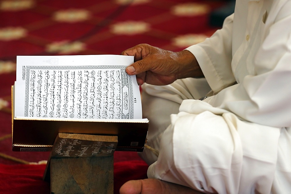 Muslim man reading an Arabic Holy Quran (Koran), Masjid Ar-Rohmah Mosque, Chau Doc, Vietnam, Indochina, Southeast Asia, Asia