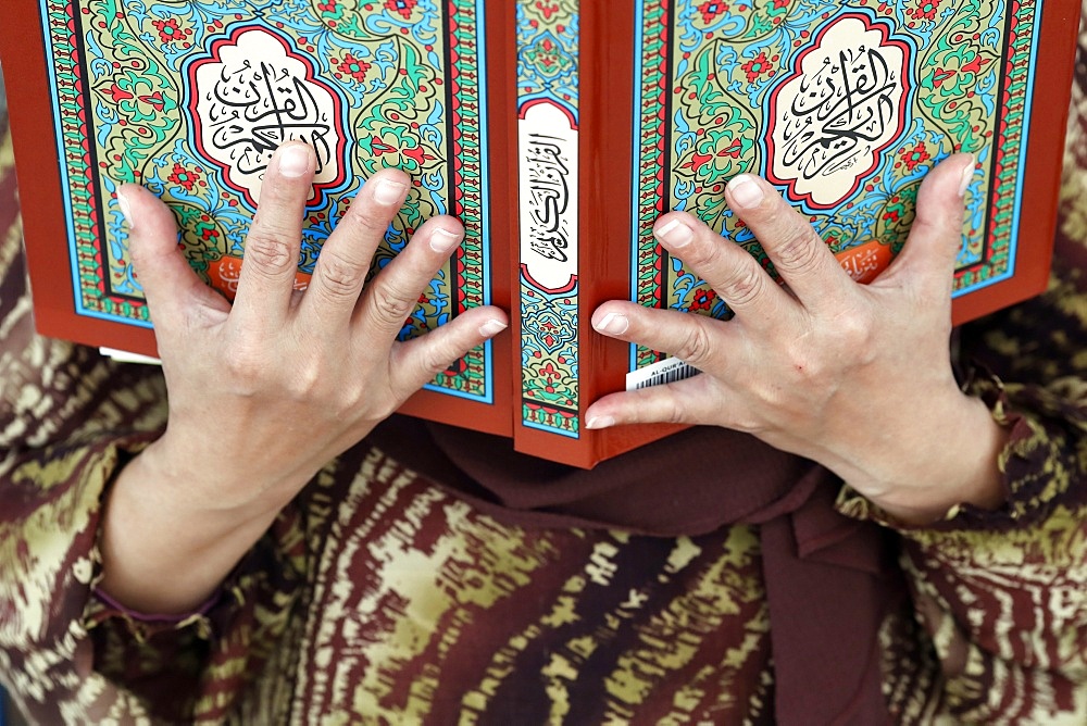 Muslim woman reading the Quran, The National Mosque (Masjid Negara), Kuala Lumpur, Malaysia, Southeast Asia, Asia