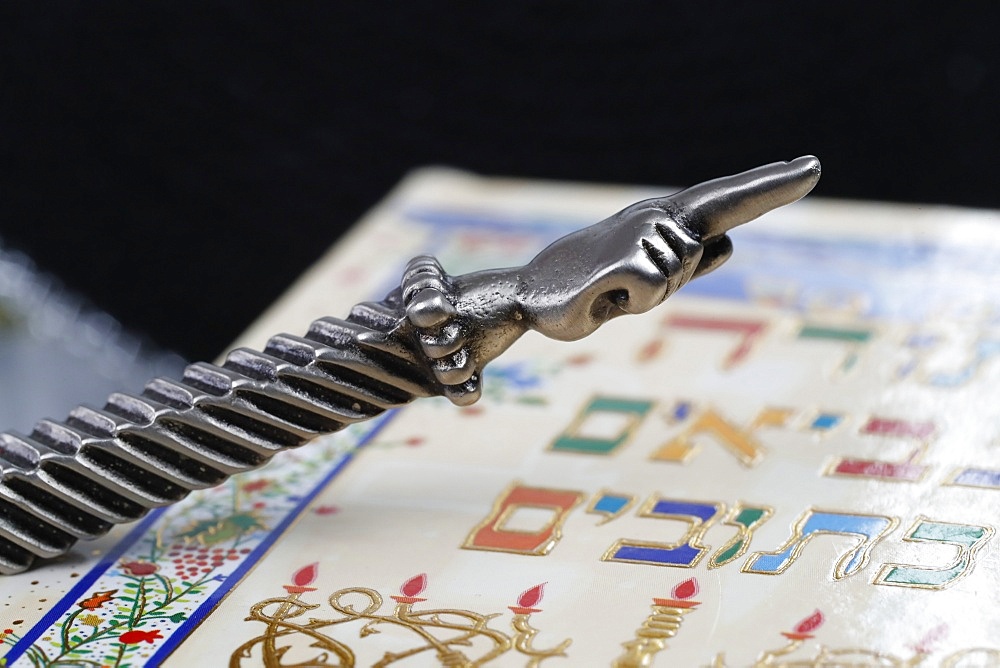 A silver Yad Jewish ritual pointer on a Torah, France, Europe