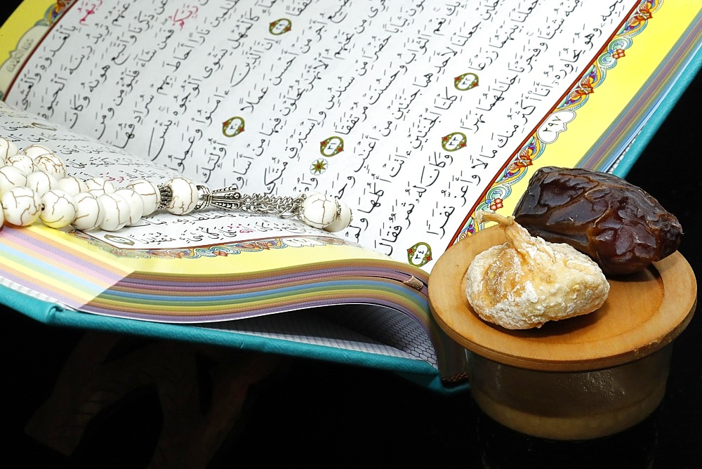 Holy Quran book with prayer beads and date, Ramadan concept, Muslim faith and religion, France, Europe