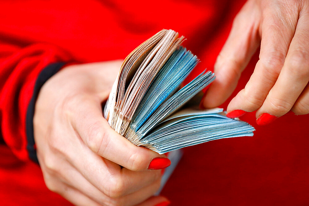 Female hand with a lot of euro banknotes, concept of wealth, success, greed and corruption, lust for money, France, Europe