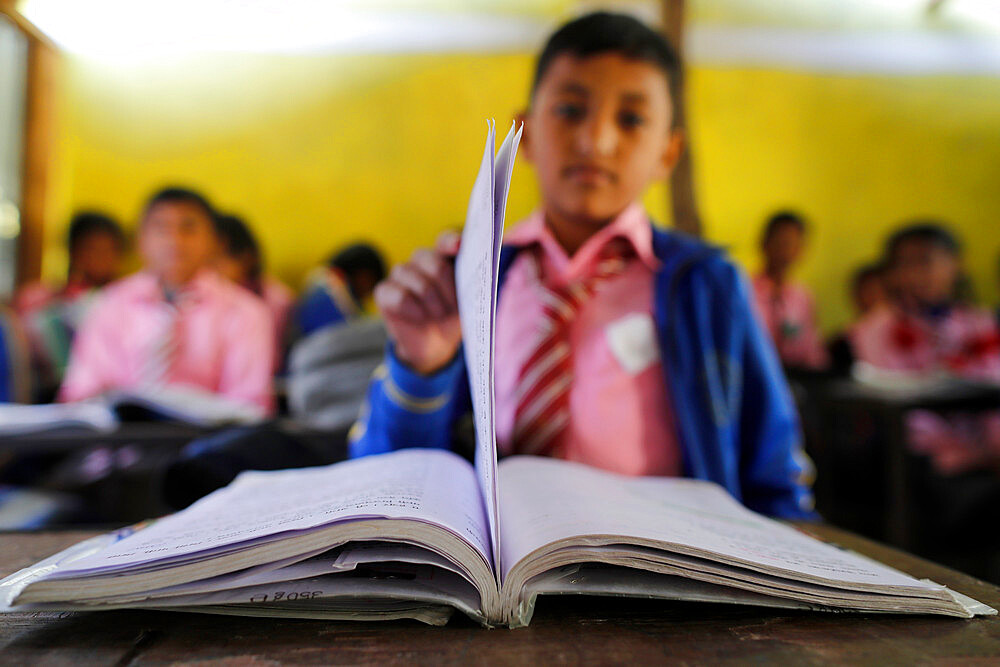 Primary school, boy with book, concept of education and school life, Lapilang, Dolakha, Nepal, Asia