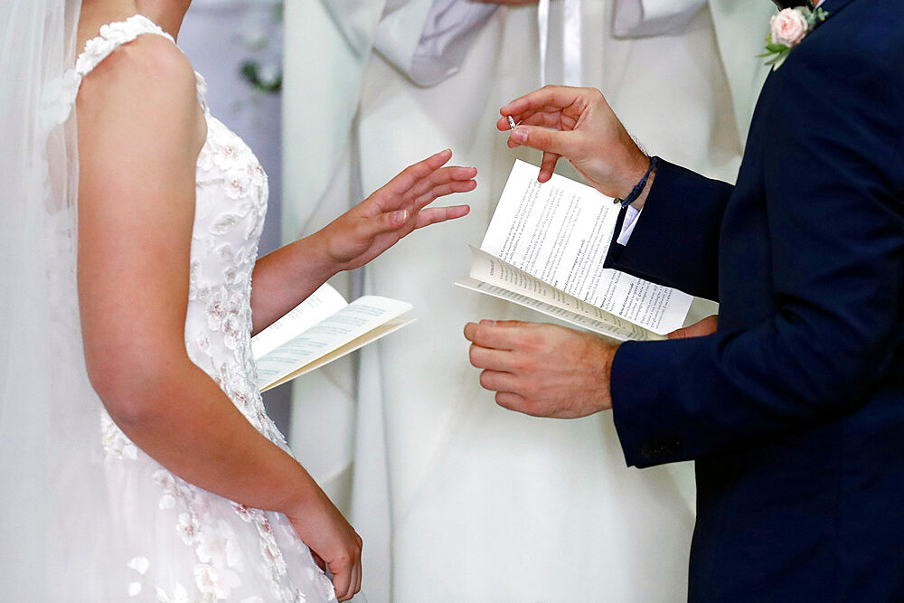 Wedding ceremony in a Catholic church, wedding rings being exchanged, France, Europe