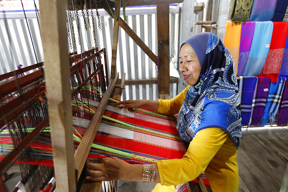 Woman working on an old silk loom, Chau Doc, Vietnam, Indochina, Southeast Asia, Asia