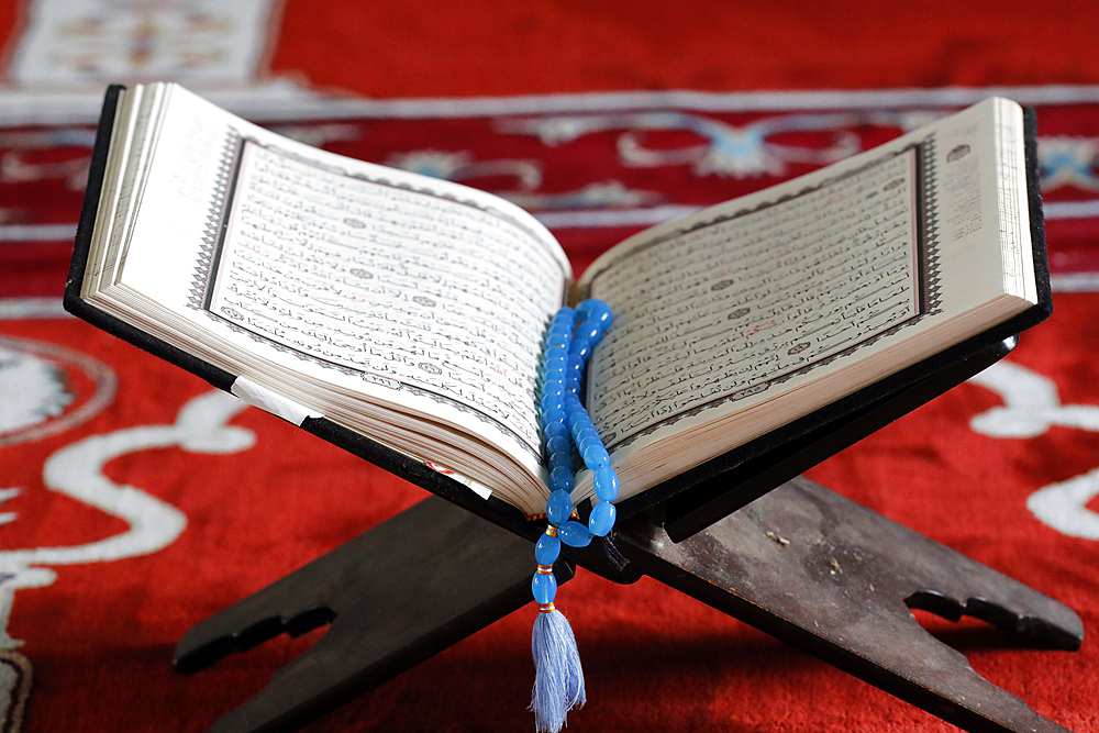 Open Quran and Muslim prayer beads on wood stand, symbol of Islam, An Giang, Vietnam, Indochina, Southeast Asia, Asia