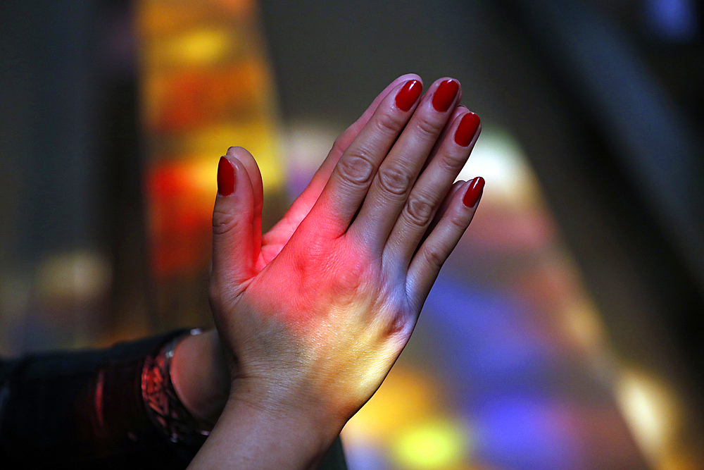 Close up of hands of woman praying in a church, Turckheim, France, Europe