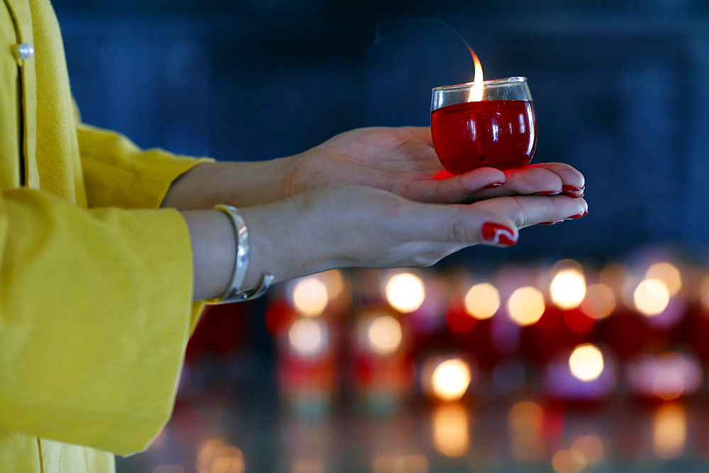 Woman at Buddhist ceremony praying with a candle, Huynh Dao Buddhist temple, Chau Doc, Vietnam, Indochina, Southeast Asia, Asia