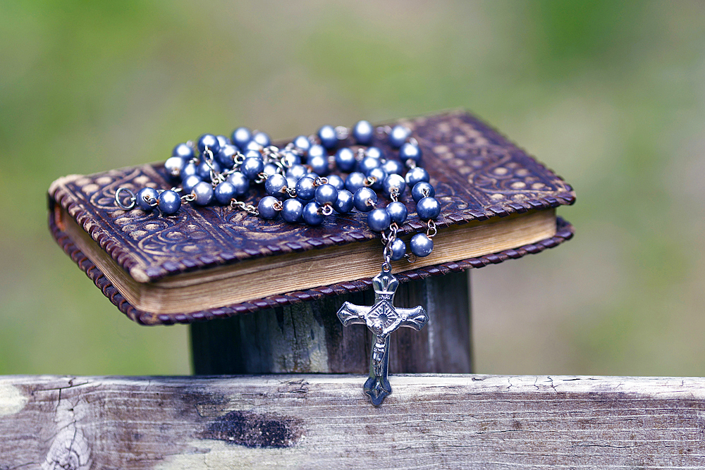 Bible and Catholic rosary beads on wood, Les Contamines, Haute-Savoie, France, Europe