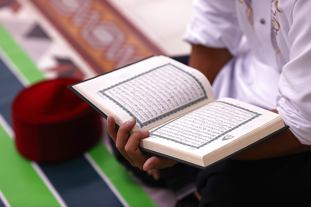 Muslim man reading a Quran, Ho Chi Minh City, Vietnam, Indochina, Southeast Asia, Asia