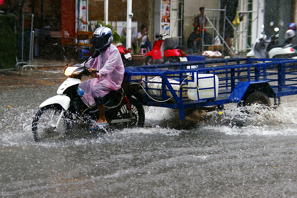 Heavy rain and water logging on road during Monsoon season, Phnom Penh, Cambodia, Indochina, Southeast Asia, Asia