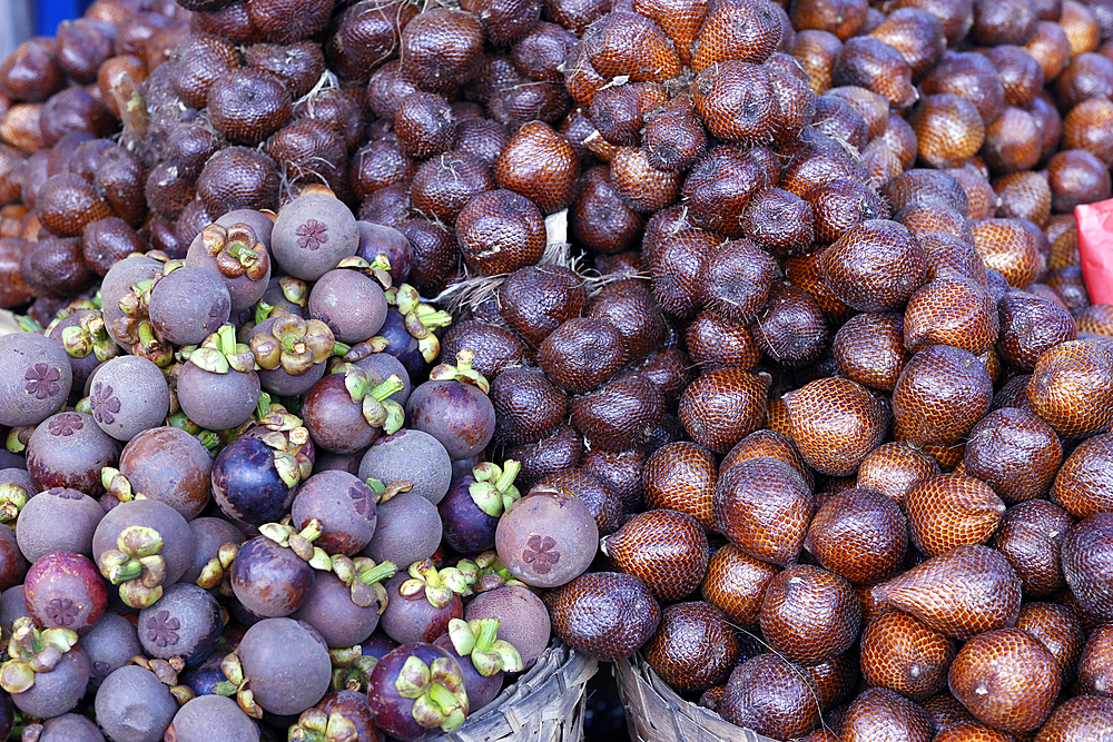 Mangosteen and salak fruit or snake fruit for sale at local food market. Yogyakarta. Indonesia.