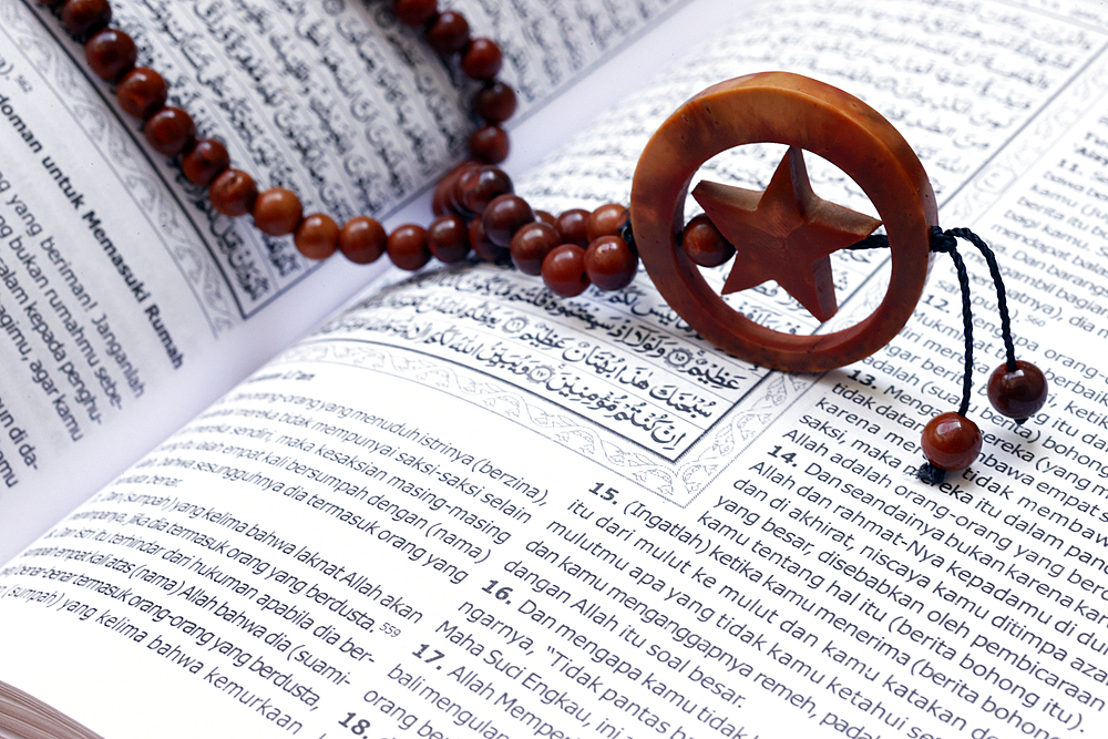 Islamic Holy Book Quran with rosary beads. Ramadan concept.