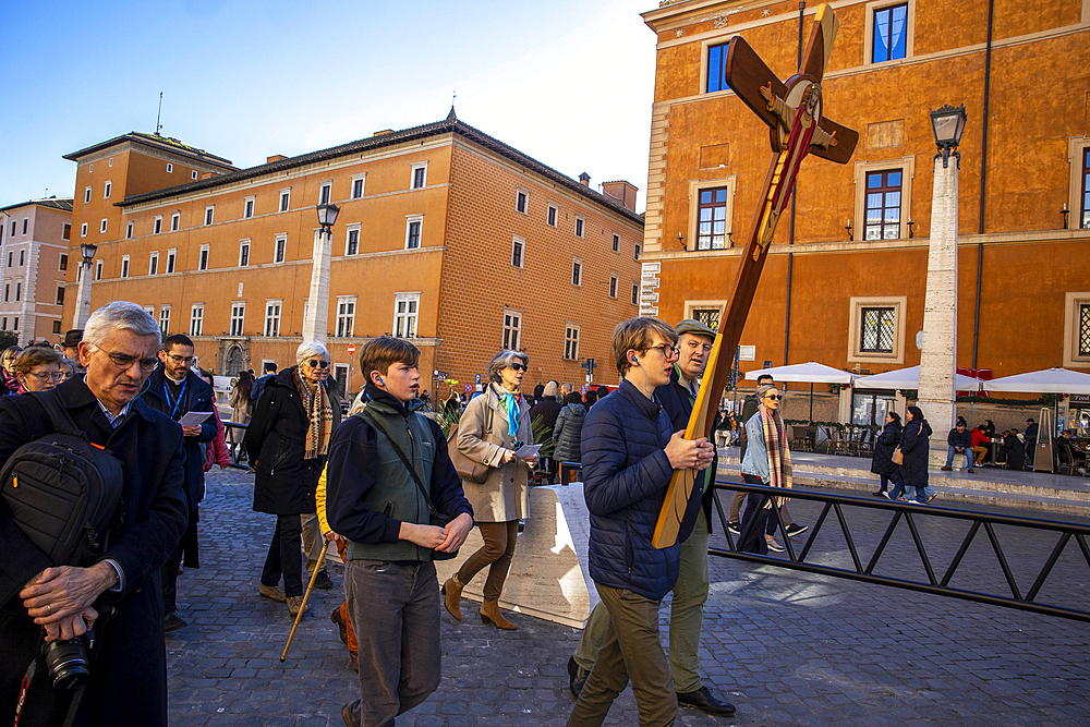 Pilgrims carry a cross on the via della Concillazione leading to the Vatican and St. Peter's basilica, during the Catholic Jubilee Year 2025 in Rome