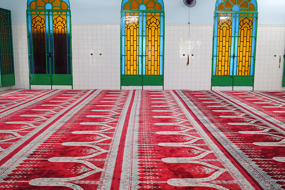 Inside the Saigon Central Mosque ( Masjid Musulman) built in 1935. Prayer hall with red carpet. Ho Chi Minh City. Vietnam.