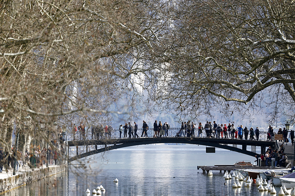 Tourists on the Pont des Amours - Lovers Bridge in Summer at Annecy Lake, Lac d'Annecy, France.