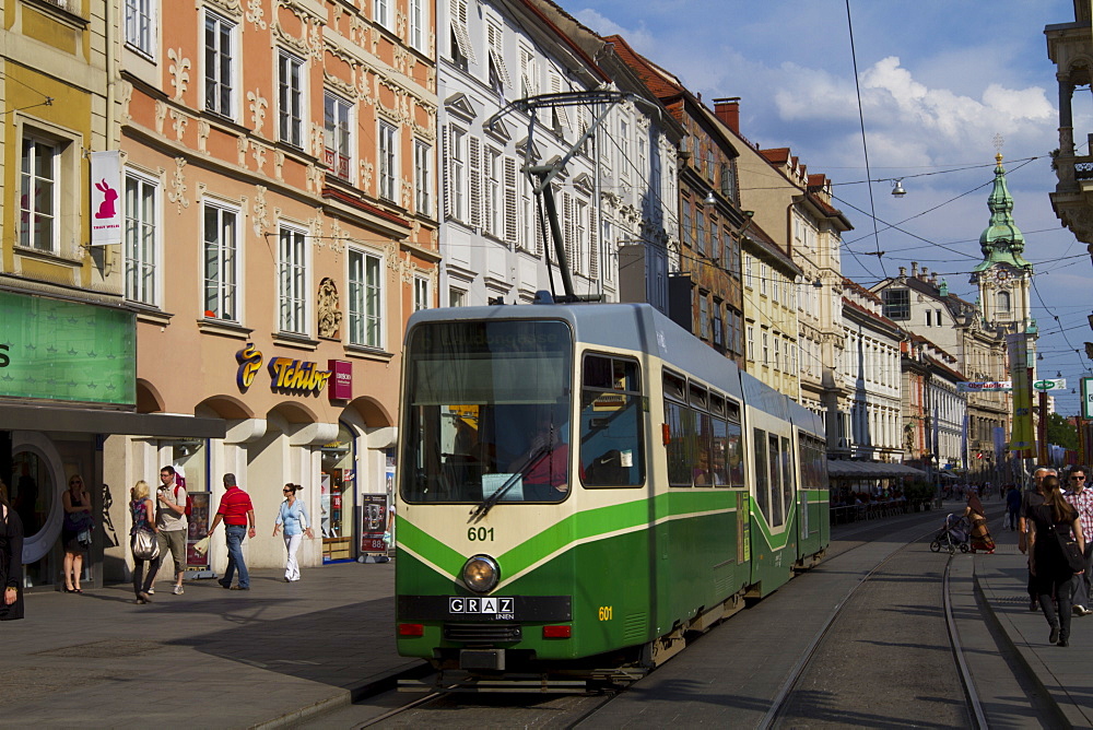 Tram on Herrengasse, with Stadtpfarrkirche (city parish church) in distance, Graz, Styria, Austria, Europe