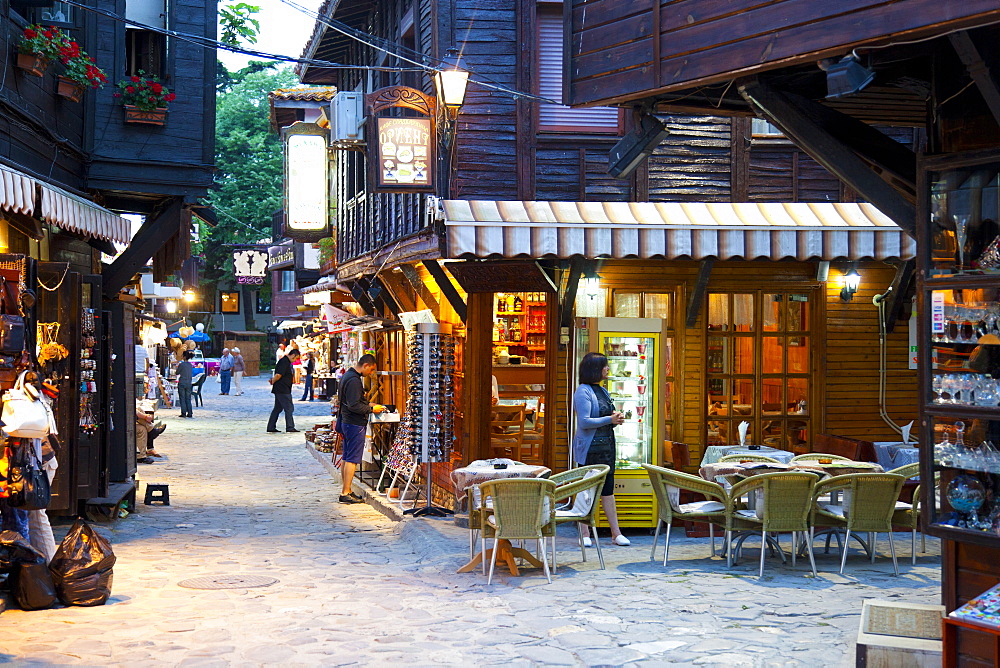 Souvenir shops and outdoor restaurants at dusk, Old Town, Nessebar, Bulgaria, Europe