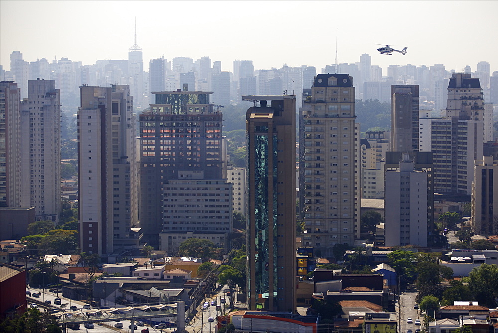 View over skyscrapers, traffic jam and helicopter in Sao Paulo, Brazil, South America