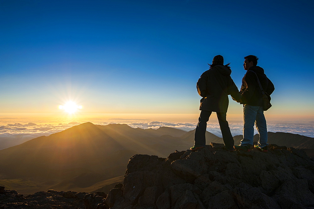 Tourists in backlight waiting for sunset. Haleakala National Park, Maui, Hawaii, United States of America, Pacific