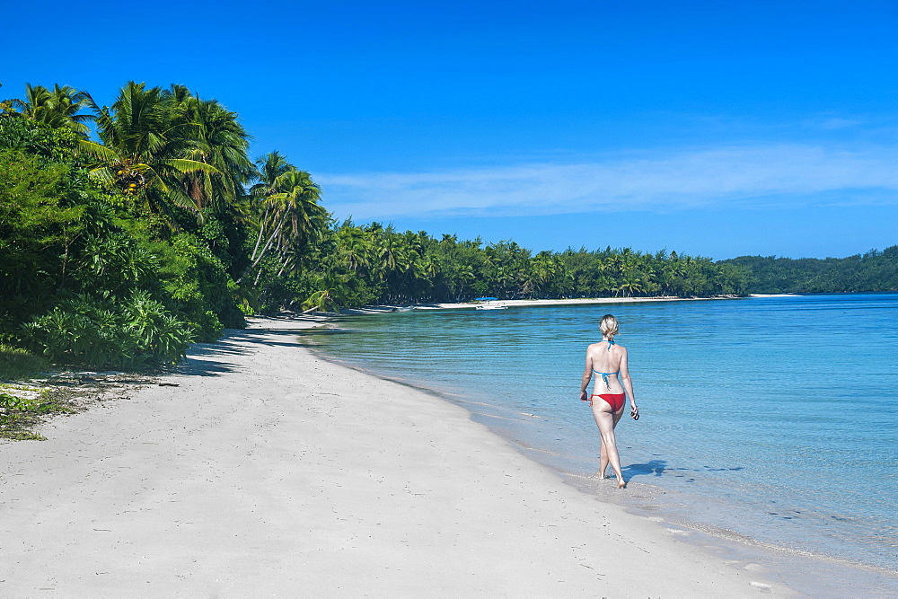 Woman walking on a a white sand beach, Nanuya Lailai island, the blue lagoon, Yasawas, Fiji, South Pacific, Pacific