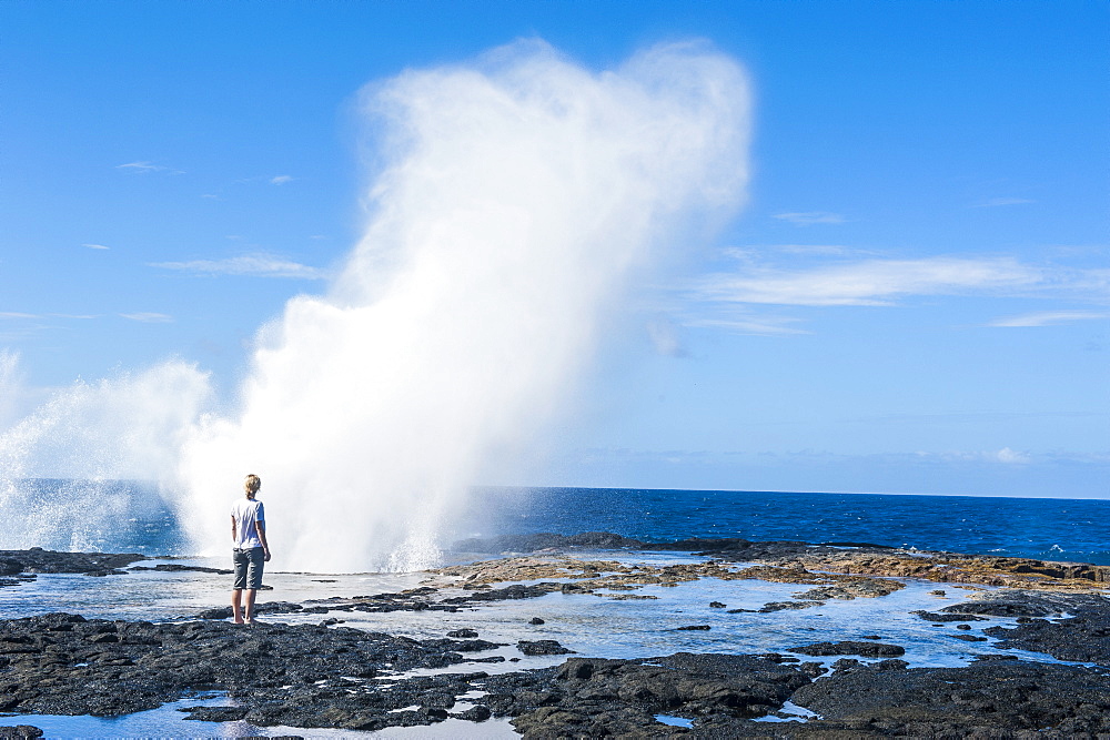 Tourist enjoying the huge waves in the Alofaaga blowholes on the south of Savaii, Samoa, South Pacific, Pacific