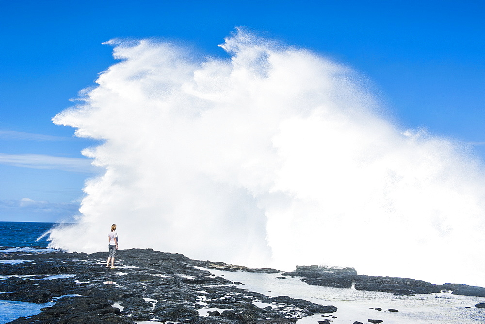 Tourist enjoying the huge waves in the Alofaaga blowholes on the south of Savaii, Samoa, South Pacific, Pacific