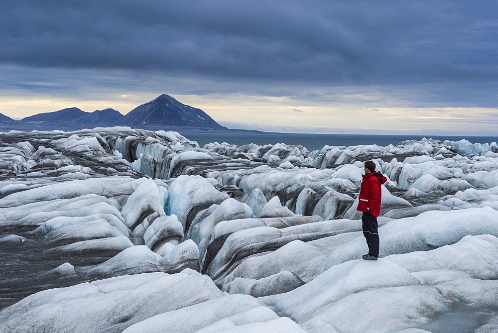 Man standing on a huge glacier in Hornsund, Svalbard, Arctic, Norway, Scandinavia, Europe 