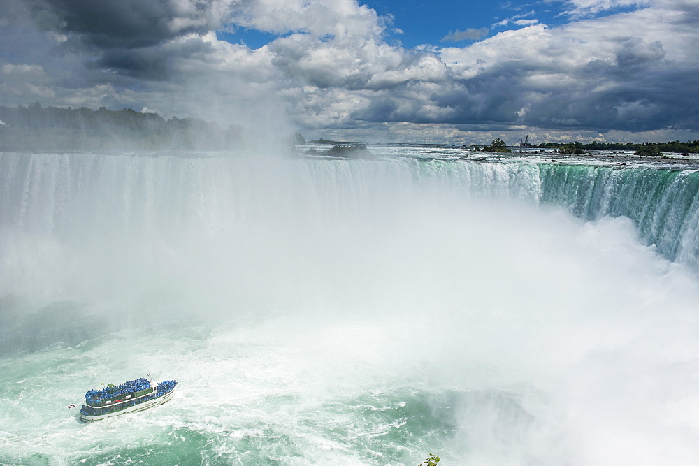 Tourist boat in the mist of the Horseshoe Falls (Canadian Falls), Niagara Falls, Ontario, Canada, North America