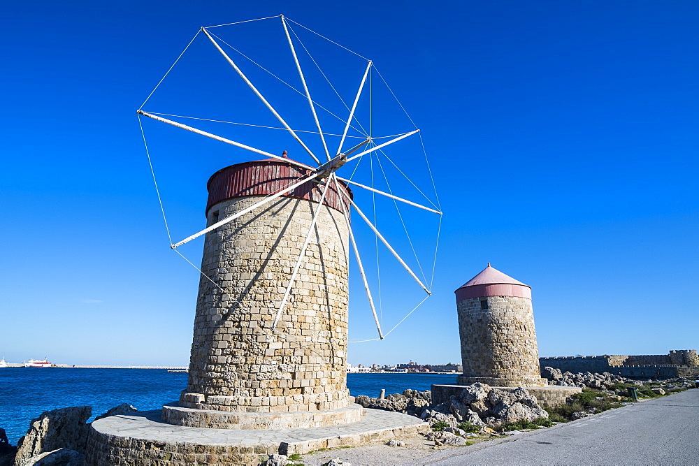 Medieval windmills at Mandraki harbour, City of Rhodes, Rhodes, Dodecanese Islands, Greek Islands, Greece, Europe