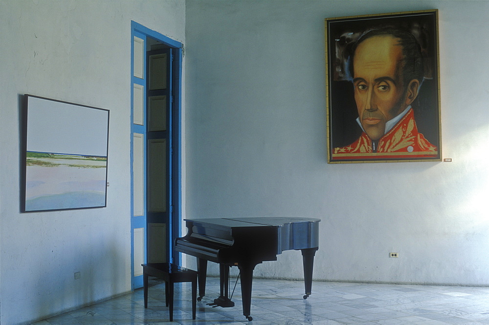 Piano in an empty room with a large portrait hanging on the wall, Havana, Cuba, West Indies, Central America