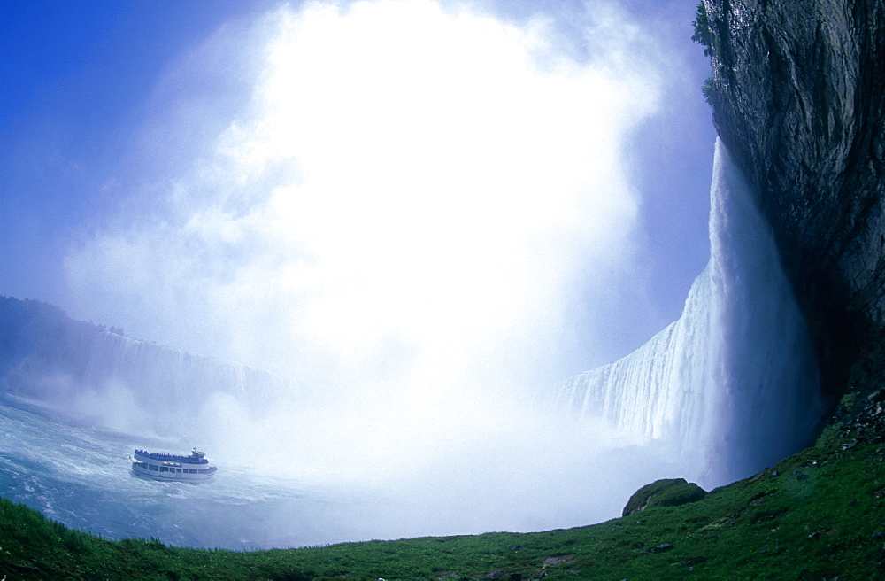 Maid of the Mist tour boat approaching the base of Niagara Falls, Ontario, Canada, North America