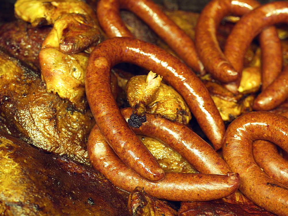 Sausages and chicken grilling in an open pit BBQ grill in Texas BBQ style, Houston, Texas, United States of America, North America