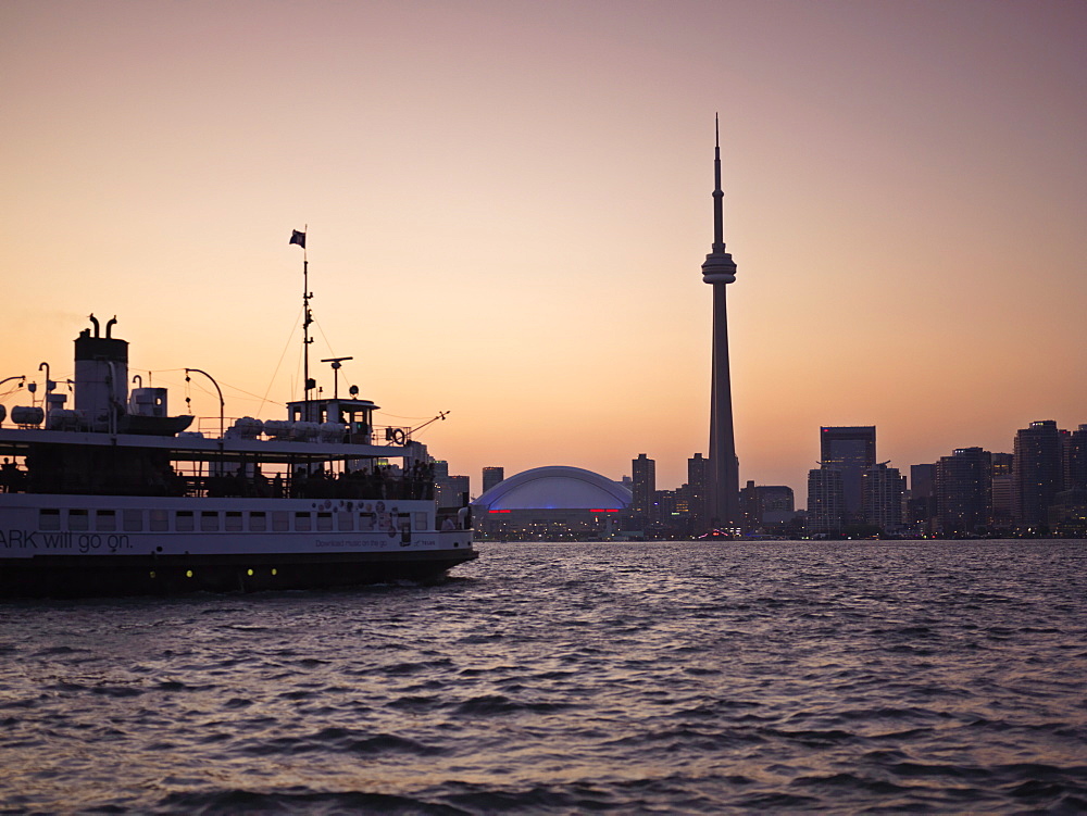 Toronto Islands ferry heading towards the city at dusk, Toronto, Ontario, Canada, North America