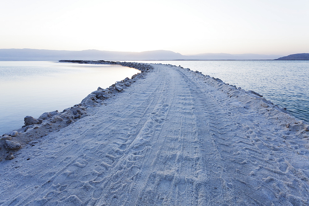 Road leading out to the sea formed by excavated salt and minerals, Dead Sea, Israel, Middle East