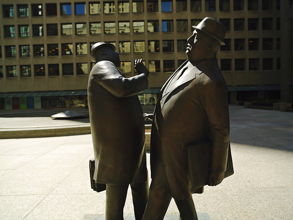 Encounter, a bronze sculpture by William McElcheran of two business men bumping into each other, Financial District, Toronto, Ontario, Canada, North America