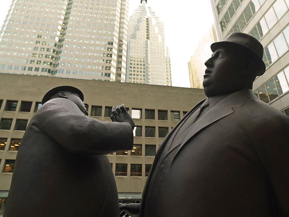 Encounter, a bronze sculpture by William McElcheran of two business men bumping into each other, Financial District, Toronto, Ontario, Canada, North America