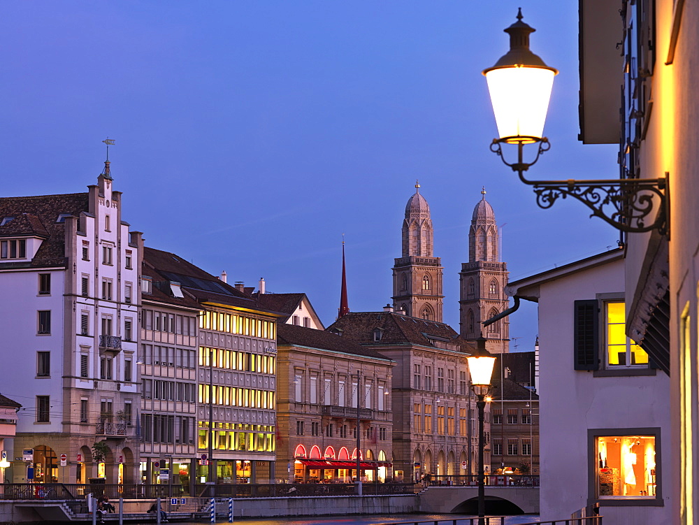 Old Town and Limmat River front with Grossmunster Church at dusk, Zurich, Switzerland, Europe