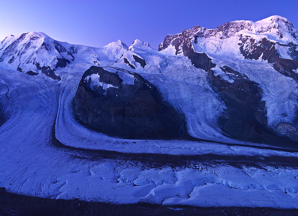 Peaks of Mount Rosa, Liskamm, and Breithorn and the Gorner Glacier as viewed from the Gornergrat under moonlight, Zermatt, Valais, Switzerland, Europe