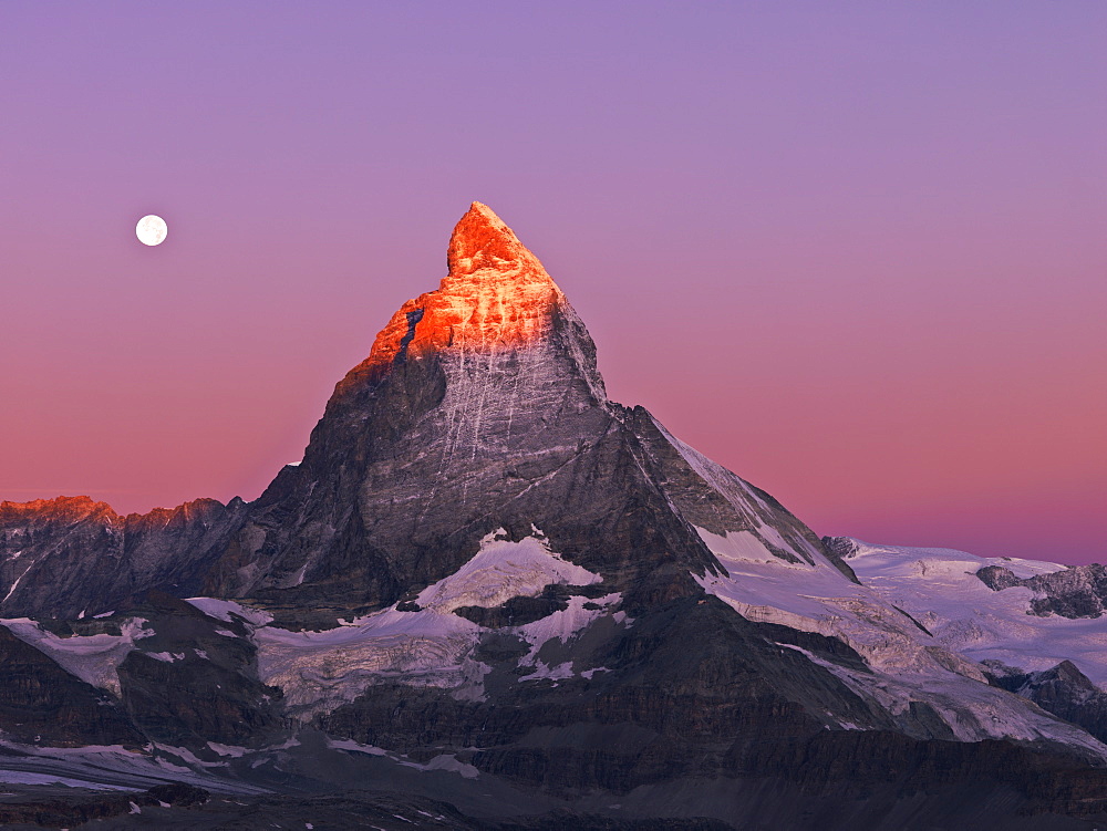 Moon setting over the Matterhorn at dawn, Gornergrat, Zermatt, Valais, Switzerland, Europe