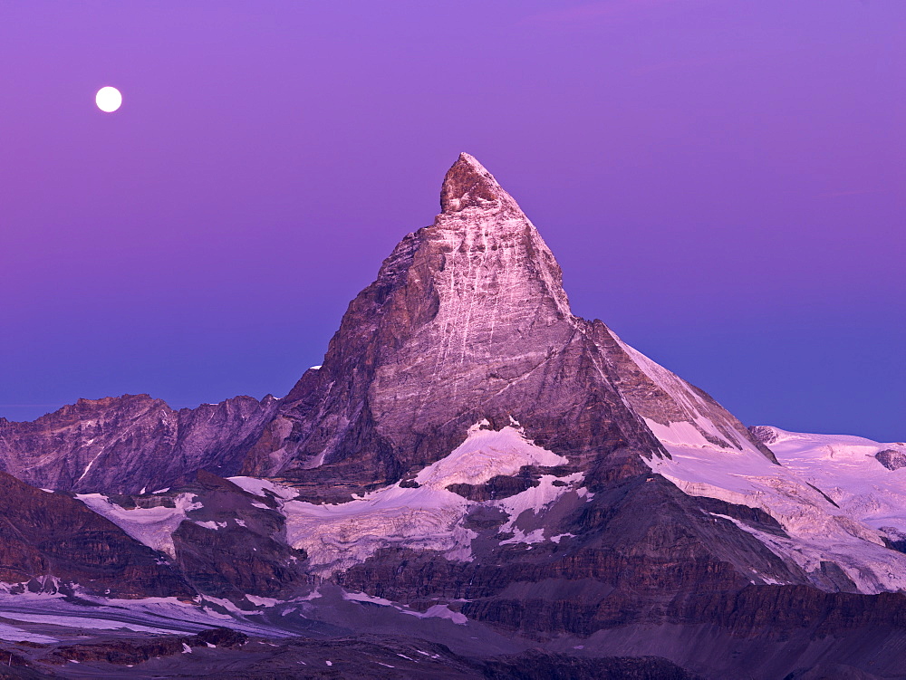 Moon setting over the Matterhorn at dawn, Gornergrat, Zermatt, Valais, Switzerland, Europe