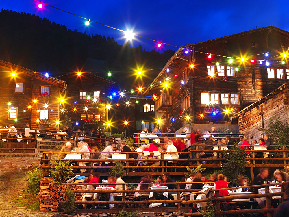 Open air diners in the town square of Binn, Goms Region, Switzerland, Europe