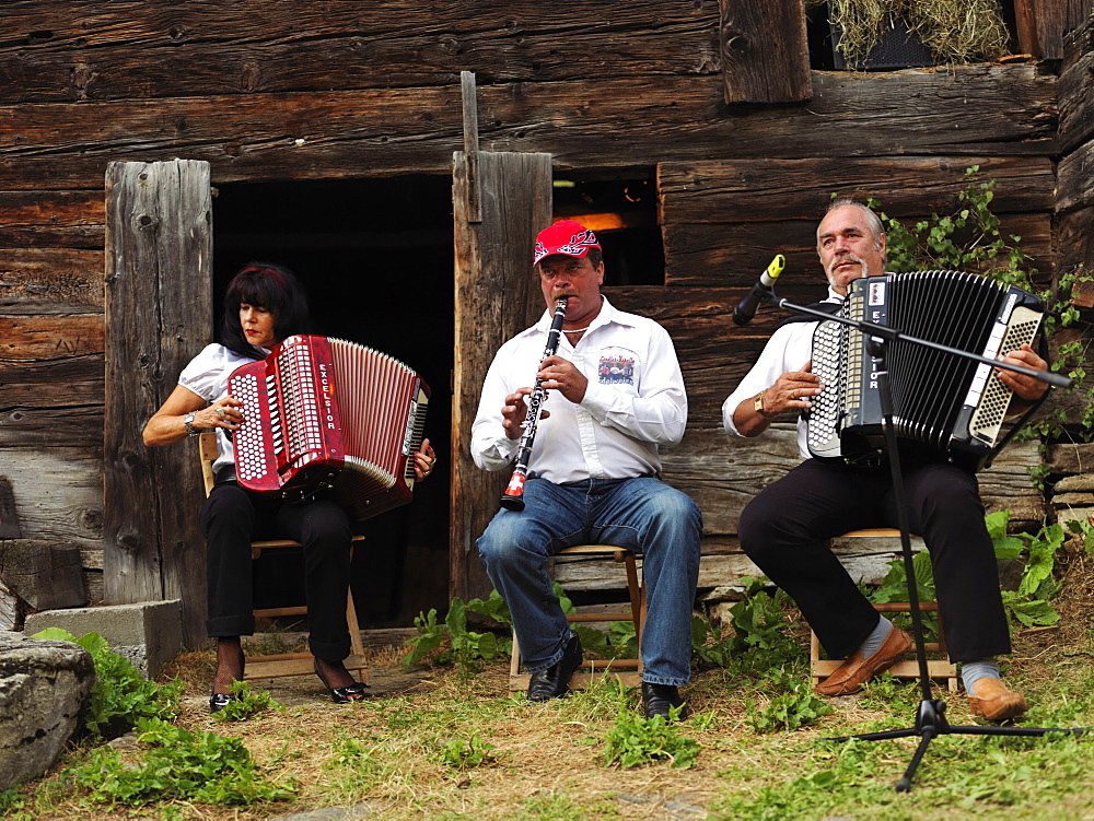 Three local musicians playing traditional music, Binn, Goms Region, Switzerland, Europe