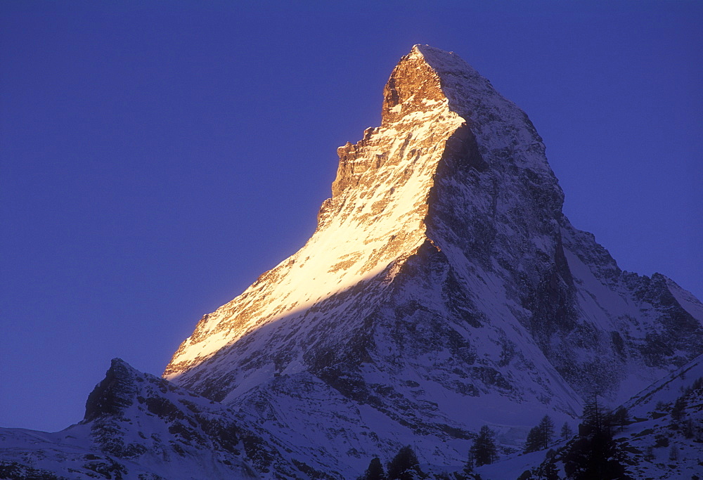 Matterhorn illuminated at sunrise, Zermatt, Valais, Switzerland, Europe