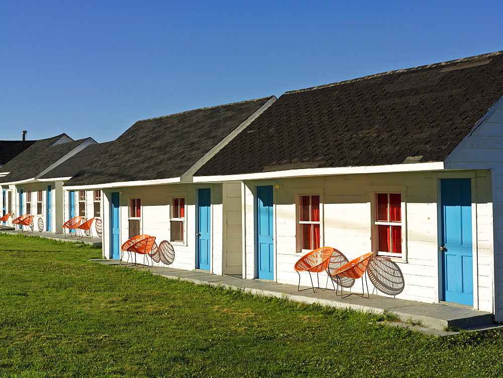 Motel units with brightly colored blue doors, L'Anse-a-Valleau, Gaspesie, Quebec, Canada, North America