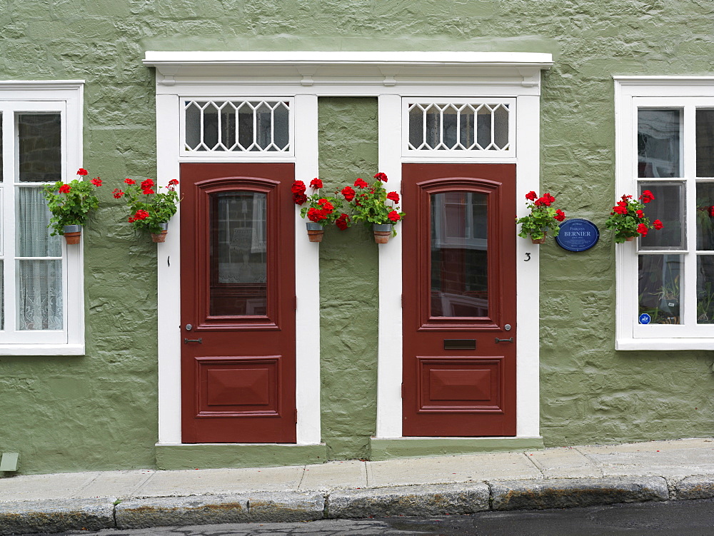 Facade of residences with doors and flowers in pots, Quebec City, Quebec, Canada, North America