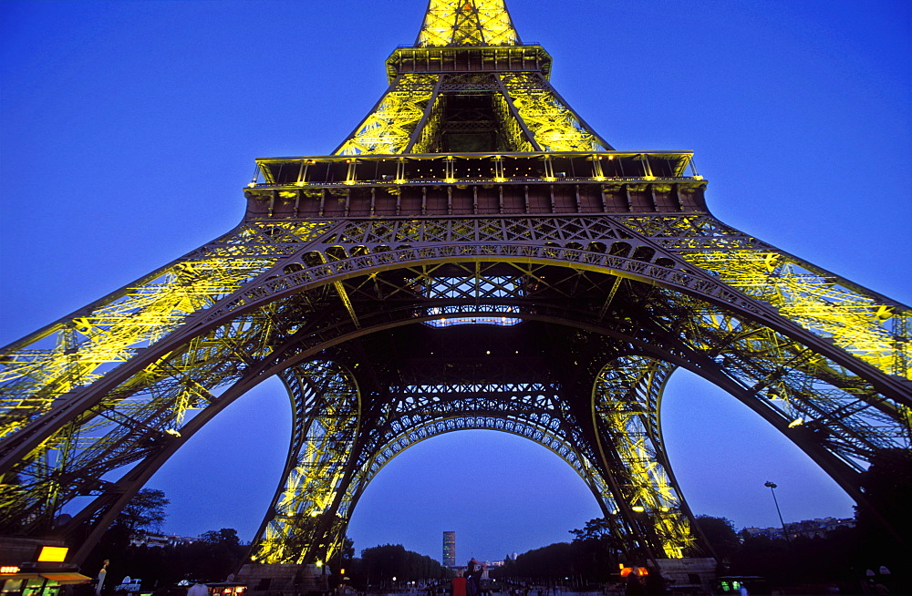 The Eiffel Tower illuminated at night, low wide angle view from below the tower, Paris, France, Europe