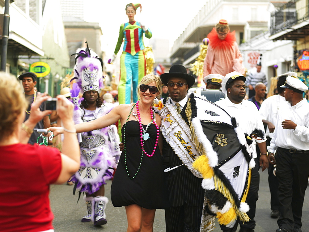 Tourist having photo taken with Grand Marshall of the parade, French Quarter, New Orleans, Louisiana, United States of American, North America