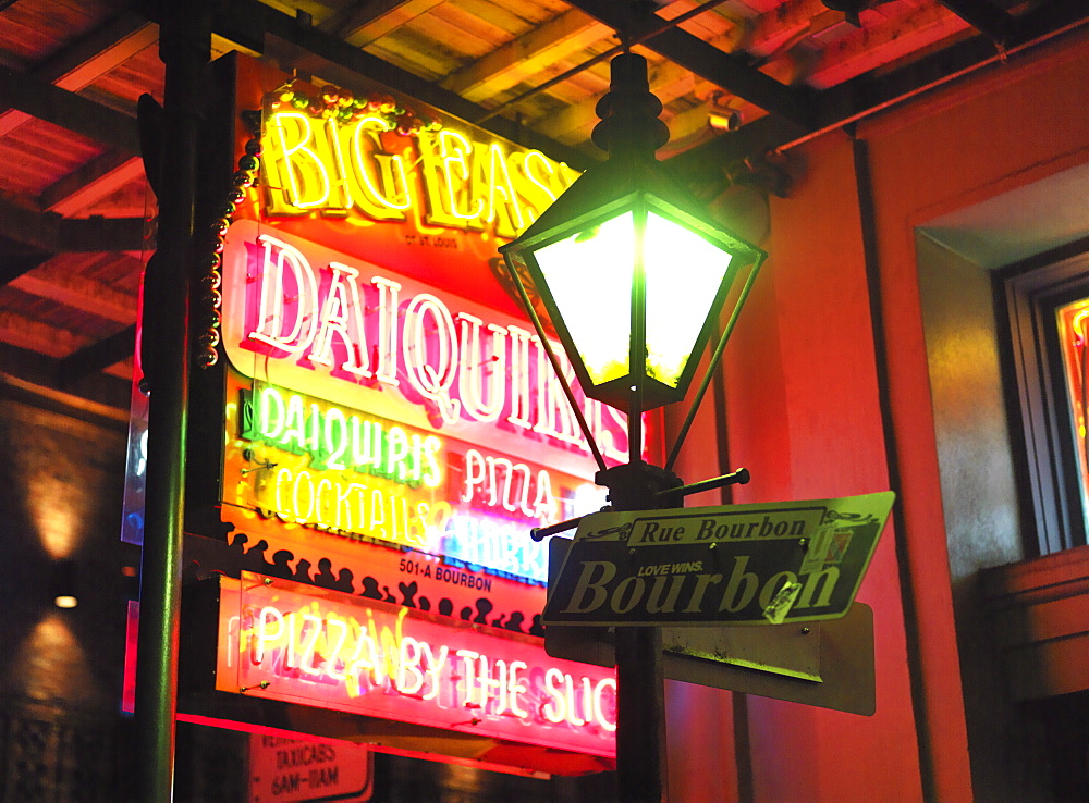 Street sign and lamp post for Bourbon Street with neon sign, French Quarter, New Orleans, Louisiana, United States of America, North America