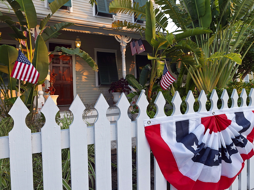 American flags on white picket fence, Key West, Florida, United States of America, North America