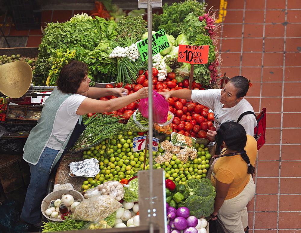 Fruit and vegetable market stall with people buying produce, Mercado San Juan de Dios, Guadalajara, Jalisco, Mexico, North America